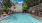 Long rectangle pool with orange lounge chairs on the tanning deck